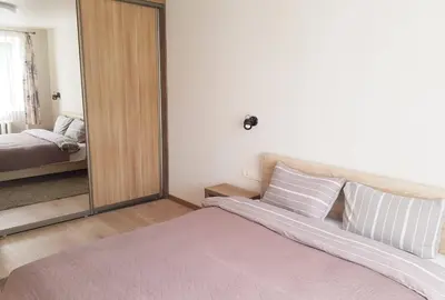 a bedroom with a large mirror and a bed at Apartamentai Vilniaus Street II in Šiauliai