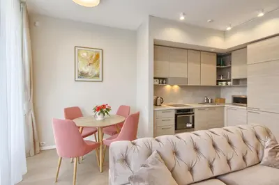a living room with a couch and a table and chairs at Svajonių apartamentai in Druskininkai
