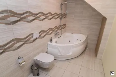 a bathroom with a tub and a toilet and a sink at Roof terrace apartment in Panevėžys