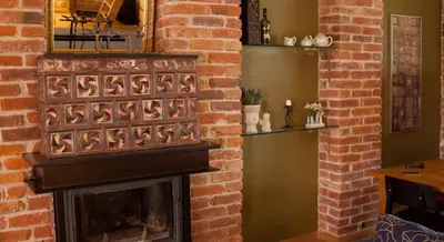 a brick wall with a fireplace in a living room at Luxury Kaunas Old Town Apartment in Kaunas