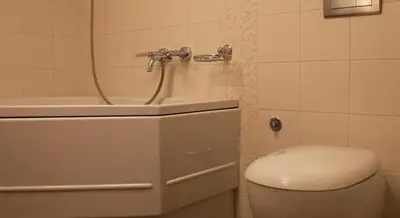 a bathroom with a toilet and a sink at Luxury Kaunas Old Town Apartment in Kaunas