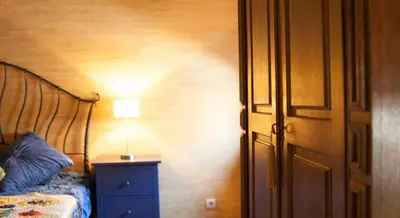 a bedroom with a bed and a lamp on a night stand at Luxury Kaunas Old Town Apartment in Kaunas