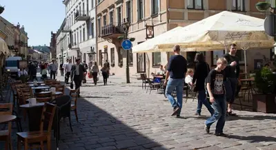 a group of people walking down a street at Luxury Kaunas Old Town Apartment in Kaunas