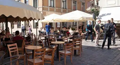 a group of people standing around tables and chairs at Luxury Kaunas Old Town Apartment in Kaunas