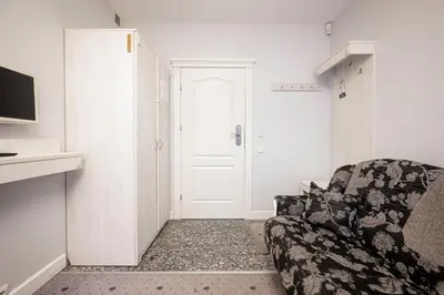 a living room with a couch and a door at Art Hotel in Druskininkai