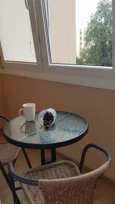 a glass table with a cup and a bowl of fruit at Vacation in druskininkai in Druskininkai