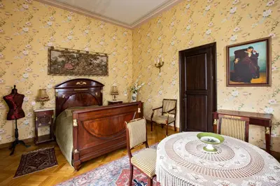a bedroom with a bed and a table in it at Burbiskio dvaras in Anykščiai