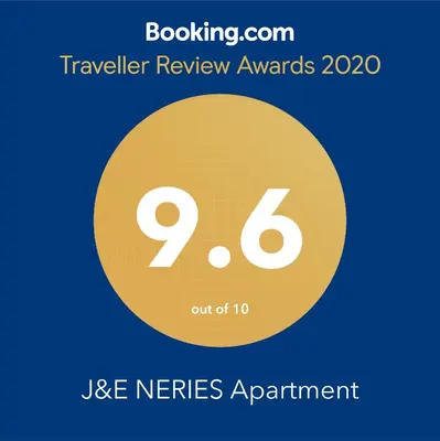 a yellow circle with the text travel review awards out at J&E NERIES Apartment in Kaunas