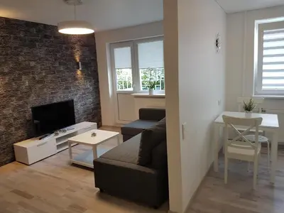 a living room with a couch and a television at J&E NERIES Apartment in Kaunas