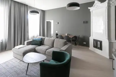 a living room with a couch and chairs and a table at APARTAMENTAI LEMBERGAS in Vilnius