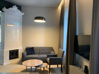 a living room with a couch and a table at APARTAMENTAI LEMBERGAS in Vilnius