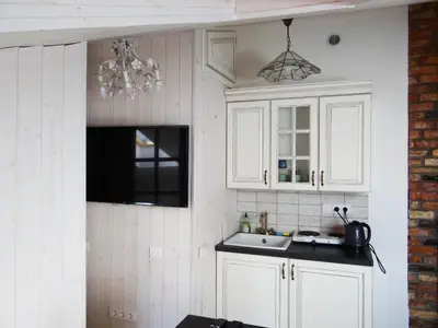 a kitchen with white cabinets and a sink at Little Provence Home in Vilnius