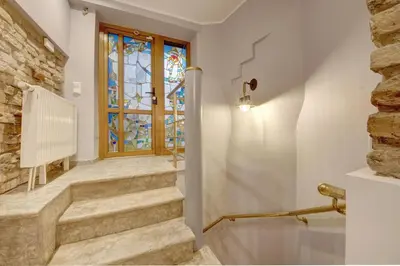 a hallway with stairs and a stained glass window at Vilnius Old town apartments in Vilnius