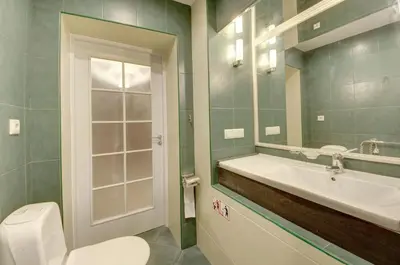 a bathroom with a toilet and a sink and a mirror at Vilnius Old town apartments in Vilnius