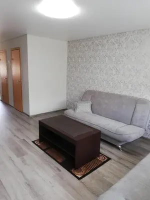 a living room with a couch and a coffee table at Apartamentai ,,ASTRA'' in Birštonas