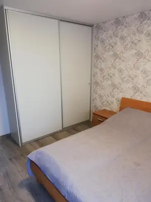 a bedroom with two closets and a white bed at Apartamentai ,,ASTRA'' in Birštonas