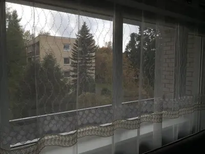 a window with a view of a building at Apartamentai ,,ASTRA'' in Birštonas