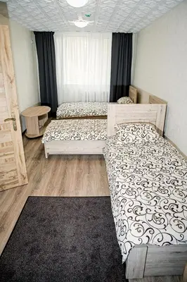 a bedroom with two beds and a window at Everena Guest House in Rokiškis