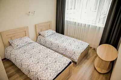 two beds in a room with a window at Everena Guest House in Rokiškis