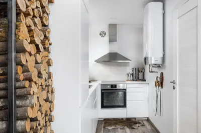 a kitchen with white appliances and a brick wall at Riese Apartments in Riese