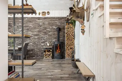 a living room with a fireplace and a wood stove at Riese Apartments in Riese