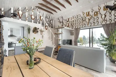 a kitchen and dining room with a wooden table and chairs at Riese Apartments in Riese