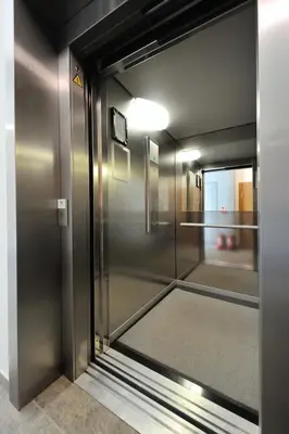 an elevator with a door open to a hallway at Valensia Apartment in Druskininkai