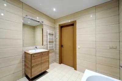 a bathroom with a sink and a shower and a mirror at Valensia Apartment in Druskininkai