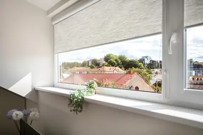 a window with a view of a house at #stayhere - Light Vilnius views Loft City Center in Vilnius