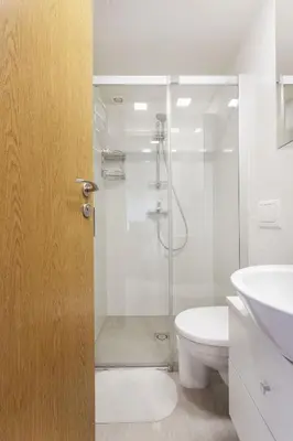 a bathroom with a shower and a toilet and a sink at #stayhere - Light Vilnius views Loft City Center in Vilnius