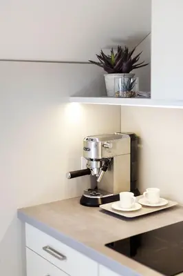 a coffee maker and two cups on a counter at #stayhere - Light Vilnius views Loft City Center in Vilnius