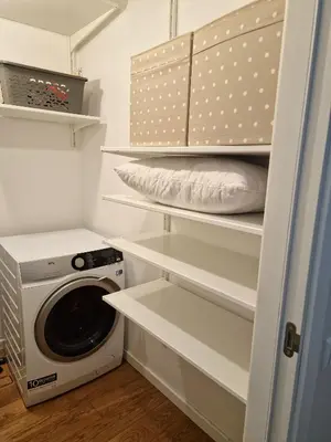 a laundry room with a washing machine and a washer at Central Stay Appartments in Šiauliai