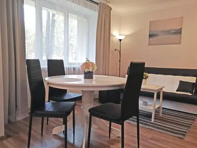 a dining room with a table and chairs at Šiauliai Central Spot Apartment - Draugystes pr. in Šiauliai