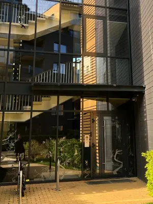 a building with a revolving door in front of it at Antakalnis Apartment in Vilnius