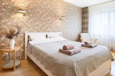 a bedroom with a bed with pillows on it at Ona`s apartment in City Center with private parking in Kaunas