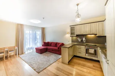 a kitchen with a red couch in a living room at Ona`s apartment in City Center with private parking in Kaunas