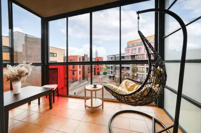 a room with a hammock hanging from the window at Ona`s apartment in City Center with private parking in Kaunas