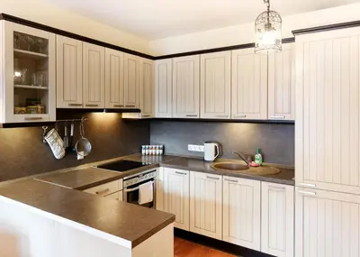 a kitchen with white cabinets and a sink at Ona`s apartment in City Center with private parking in Kaunas
