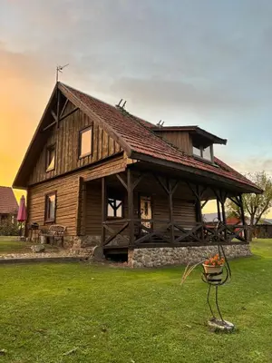 a large wooden house in a field of grass at Homestead 