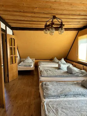 a room with two beds and a chandelier at Homestead 