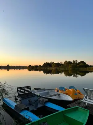 a boat is docked on a lake at sunset at Homestead 