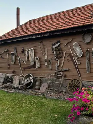 a building with a bunch of tools on the side of it at Homestead 