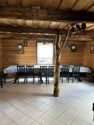 a dining room with a table and chairs and a tree at Homestead 