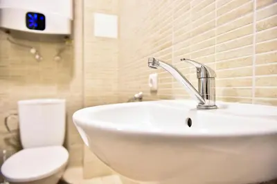 a bathroom with a sink and a toilet at Hostel Laurita in Kaunas