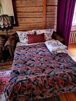 a large bed in a room with a couch at Vila Marta in Druskininkai