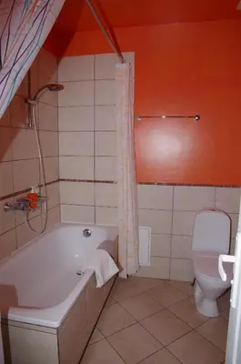 a bathroom with a tub and a toilet at Vila Marta in Druskininkai