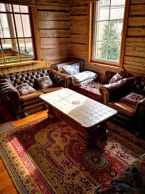 a living room with leather couches and a coffee table at Vila Marta in Druskininkai