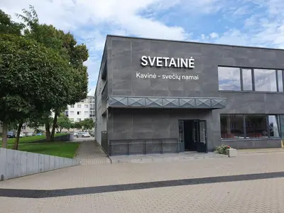 a building with a sign on the side of it at Svetainė in Jonava