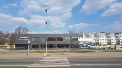 a large building with a sign in front of it at Svetainė in Jonava