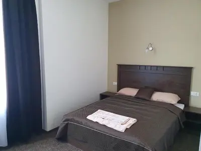 a bedroom with a bed with two towels on it at Svetainė in Jonava